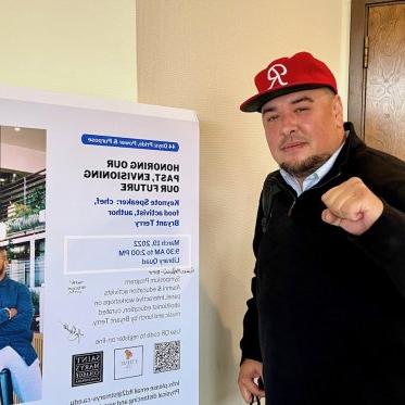 a man standing next to a poster